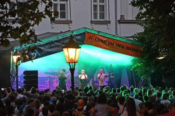 Beleuchtete Bühne am Wilhelmsplatz mit Musikern der Band Floot
