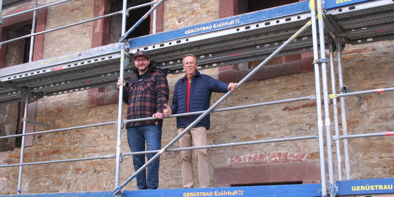 Fabian Froböse und Friedhelm Honig stehen auf einem Baugerüst vor dem Ratskeller Moringen